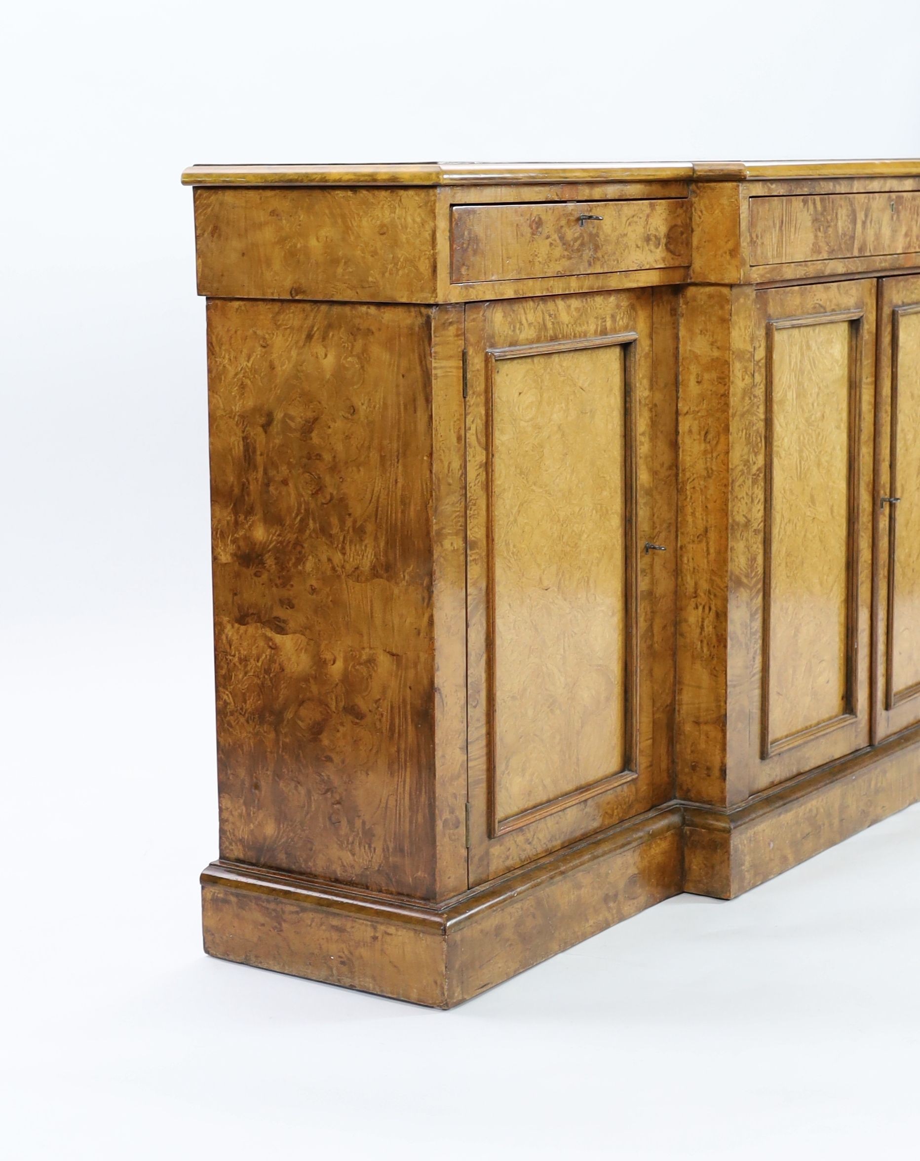 A Victorian walnut breakfront dwarf bookcase, W.195cm D.44cm H.95cm